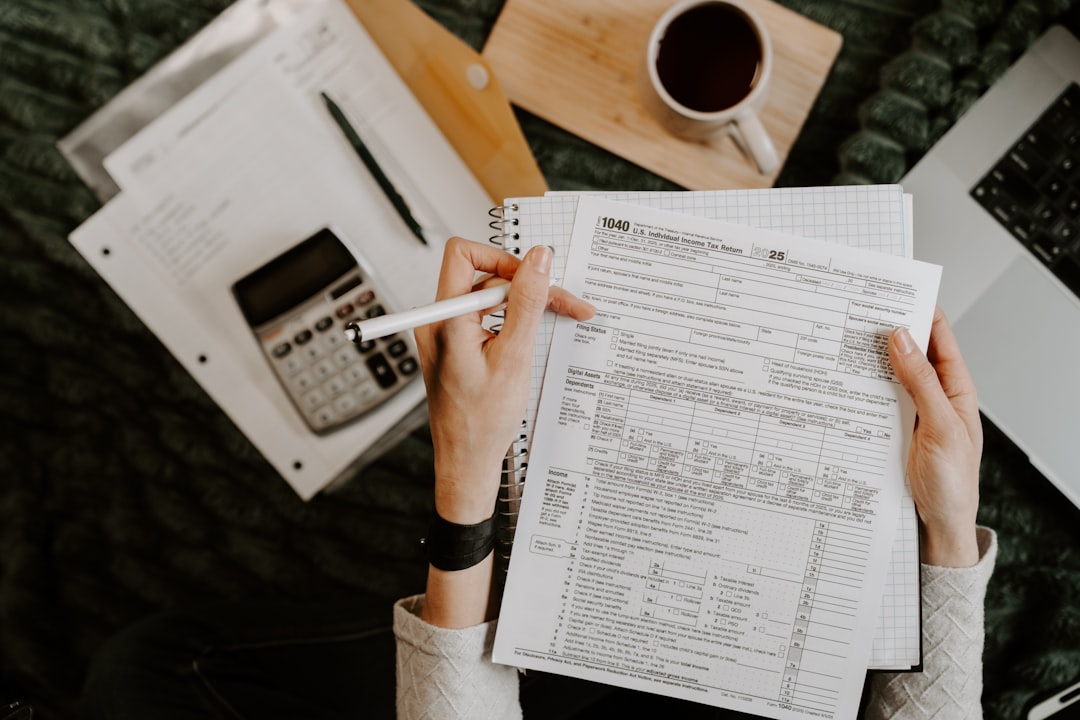 Small business financial readiness review with calculator, laptop and business documents
